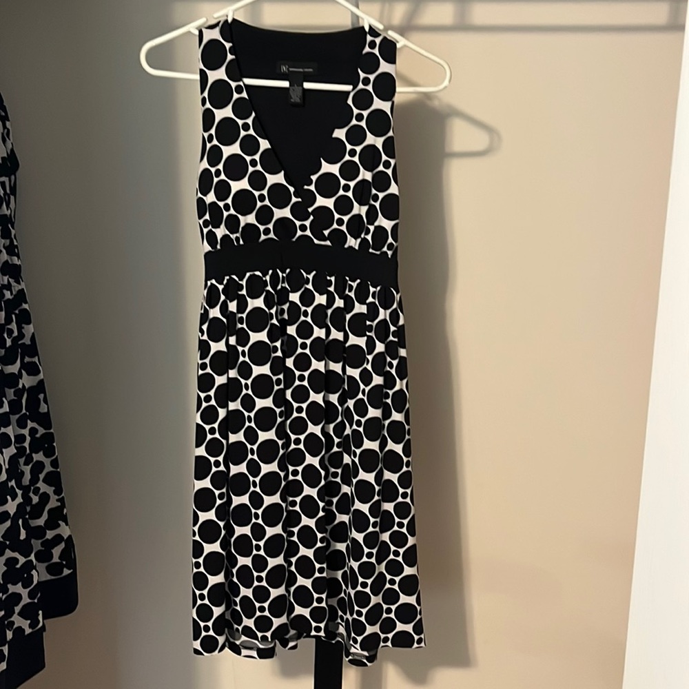 Inc black and white polka dot dress.  Tie in back. Sleeveless.